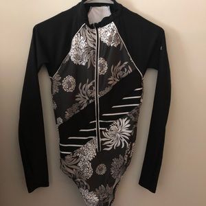 Long sleeved surfer style one piece swimsuit